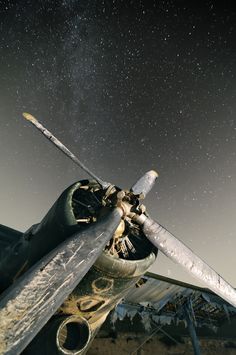 an old airplane with the stars in the sky