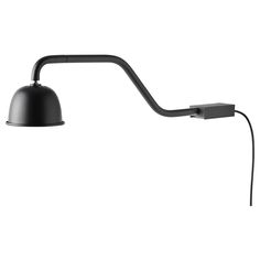 a black lamp on a white background with a cord attached to the arm and one light plugged in