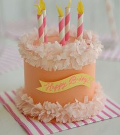 a birthday cake with pink and yellow candles