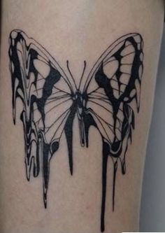 a black and white butterfly tattoo on the leg