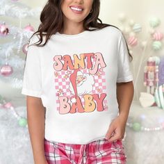 Looking for the perfect holiday outfit? Look no further than our Santa Baby holiday tee! This eye-catching t-shirt is sure to be a hit at any festive gathering. With its whimsical Santa Baby design, you'll be spreading joy and merriment wherever you go. Crafted from high-quality materials, this tee is not only stylish but also comfortable to wear all day long. Make a statement this holiday season with our Santa Baby tee - available in a variety of sizes to fit everyone on your shopping list. Whether you're dressing up for a winter wonderland or simply lounging at home, this tee is a must-have addition to your wardrobe. This classic unisex jersey short sleeve tee fits like a well-loved favorite. Soft cotton and quality print make users fall in love with it over and over again. These t-shirt Whimsical Santa, Your Shopping List, Baby T Shirts, Holiday Outfit, Santa Baby, Baby T Shirt, Baby Design, Baby Tshirts, Baby Tee