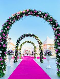 a pink and white wedding aisle decorated with flowers