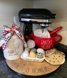 an assortment of kitchen items are displayed on a counter top in front of a mixer