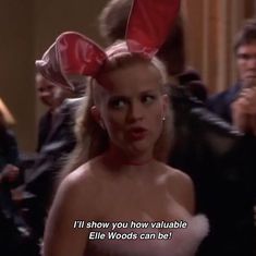 a woman with bunny ears on her head in a room full of other people and text that reads, i'll show you how valuable ellen woods can be