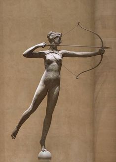 a statue of a woman holding a bow and arrow