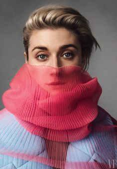 a woman wearing a pink scarf over her face