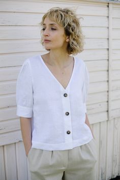 "White women V-neck blouse. Made from locally manufactured pre-washed linen fabric and is perfect for all seasons. - Handmade in our studio from 100% linen - Relaxed fit - V-neck - Buttons opening at the front side - Elbow-length puffed sleeves with cuff and button FABRIC&CARE Available in any other color of listed linen. We use medium weight and 100 % Oeko-Tex certified linen, which means that it meets ecological requirements. Hand wash or gently machine washable 30oC, hang dry recommended, Summer Linen Blouse With Puff Sleeves, Casual Linen Puff Sleeve Tops, White Linen Blouse With Puff Sleeves, Linen Blouse, Puffed Sleeves, V Neck Blouse, Linen Top, Linen Dresses, Lithuania