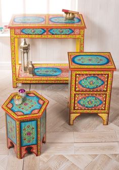 three pieces of colorful painted furniture on the floor