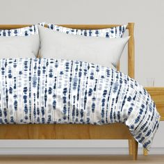 a bed with blue and white pillows on it