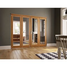 an empty room with wooden floors and glass doors