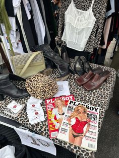 a table topped with lots of clothes and shoes