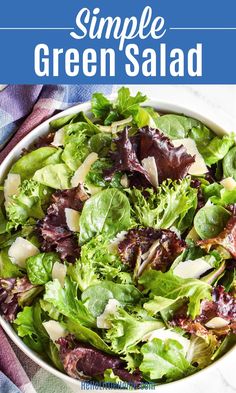 a salad with lettuce, cheese and other greens in a bowl on a table