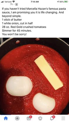 two eggs are being cooked in a pan with red sauce and cheese on the side