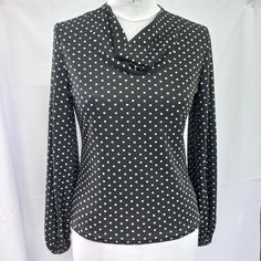 a black and white polka dot blouse on a mannequin