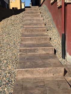 a set of stone steps leading up to a red building