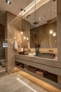 a bathroom with a sink, mirror and lights on the wall next to the toilet