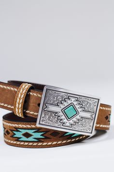 This ladies Ariat belt by M&F Western Products is so stylish. Genuine leather with white buck lace stitching that runs the outer edge of the belt. The inlay is designed with an embroidered turquoise pattern. Will go with a variety of styles and looks. Sizing Guide: Ariat belts are measured from the end of the strap on the buckle side to the center of the middle hole. The best rule of thumb is to buy a belt 2” larger than your waist/pant size. Small: 30” Medium: 34” Large: 38” XLarge: 42” Western Belts For Rodeo, Small Western Belts, Country Belts For Women, Leather Belts Western, Western Belts For Women, Southern Dressing, Ariat Belts, Cowgirl Belt Buckles, Texas Belt Buckle