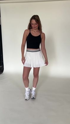 Our Ivory Striped Tennis Skirt has our same iconic pleated design, but is made with a lighter material. The skirt features built-in spandex shorts that include a comfortable fit and side pockets for storage. The black and white band snatches in the waist, making this a skirt that will look flattering on everyone. This exclusively designed Gold Hinge skirt can take on any activity such as golf, tennis, running and more. Chic White Skirt With Built-in Shorts, Chic White Stretch Tennis Skirt, Chic White Tennis Skirt With Built-in Shorts, White Pleated Sporty Shorts, Sporty Mini Pleated Skirt, Sporty White Pleated Shorts, White Mini Tennis Skirt With Elastic Waistband, Sporty Short Pleated Skirt For Summer, White Stretch Pleated Shorts