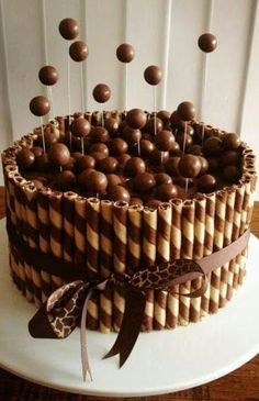 a cake with chocolate and candy sticks on it