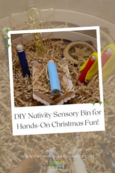 A DIY Nativity sensory bin featuring wooden peg figures dressed in felt to represent Mary, Joseph, and baby Jesus in a manger. The bin is filled with shredded paper to resemble hay, along with simple props like a gold pipe cleaner angel and animal figurines, creating a hands-on Christmas activity for kids. Nativity Fine Motor Activities, Nativity Sensory Play, Nativity Sensory Bin, Diy Sensory Bin, Holiday Family Activities, Christ In Christmas, Scented Play Dough, Story Of Christmas