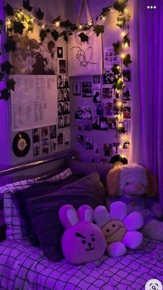 a bedroom with purple lights and stuffed animals on the bed