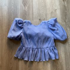 Elliatt Vanadium Blue Oversized Puff Sleeve Open Back Blouse Top Size Small New With Tags Soo Cute Color Is A Blue -Ish Purple-Ish Hue To Me Very Pretty And Unique Elegant And Classy ! Retail Value Is $190.00 + Tax Please Check All Pictures And Video Sold As Is !! No Trades Anyone Asking Will Be Blocked! Reasonable Offers Will Always Be Considered ! Check My Closet For More Elliatt Items Trusted Reliable Seller ! Check My Reviews Over 7,600 + Sales No Low Balling Tags: Princess Polly Lulus Nords Chic Blue Puff Sleeve Long Top, Casual Purple Puff Sleeve Blouse, Casual Purple Blouse With Puff Sleeves, Blue Puff Sleeve Top With Ruffles, Blue Padded Short Sleeve Blouse, Purple Puff Sleeve Top With Ruffles, Purple Ruffle Puff Sleeve Tops, Chic Blue Puff Sleeve Top, Spring Blue Puff Sleeve Tops