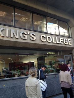 people are walking in front of the king's college