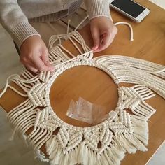 a person is making a piece of art out of rope