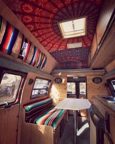 the interior of an rv with many different colored ties on the walls and ceiling in it