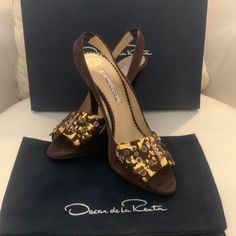 Beautiful Oscar De La Renta Dark Brown Suede With Gold Leaf Amber Slingback Pumps Beautiful And Never Worn. Come With Original Box And Dust Cover. Size 38.5 / 7 Designer Brown Slingback Pumps For Evening, Luxury Brown Slingback Pumps For Evening, Luxury Leather Sole Slingback Sandals For Party, Luxury Brown Slingback Pumps For Party, Designer Slingback Sandals With Leather Sole For Evening, Designer Slingback Pumps With Leather Sole For Party, Oscar Dela Renta, Gold Strappy Sandals, Plaid Heels