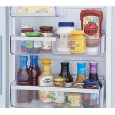 an open refrigerator filled with lots of different types of condiments and sauces