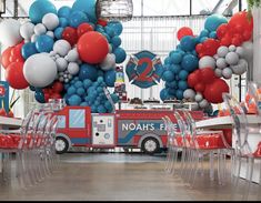 a firetruck decorated with balloons and streamers for a birthday or baby shower