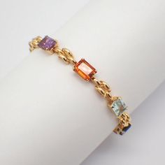 "Vintage 18k (.750) yellow gold line bracelet, decorated with emerald-cut Citrine, Tourmaline, Topaz, Garnet and Amethyst stones. This stunning bracelet is 7 1/8\" long, 1/4\" wide, weighing 16.2 grams. EA4726" Amethyst Stones, Colored Gems, Gold Line, Amethyst Stone, Chain Link Bracelet, Emerald Cut, Link Bracelets, Arm Band, Chain Link