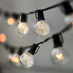 several light bulbs are hanging from a string with lights on them and one bulb is turned on