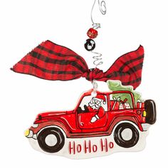 a christmas ornament with a red truck and plaid bow on it's head