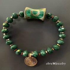 Look no further than the Green Spiral Bracelet if you're looking for a simple yet elegant addition to your wardrobe. This beautiful bracelet features green crystal beads with a big green Nepal tribal bead and a brass spiral charm to pull it all together. You can also pair this bracelet with other Ebru Jewelry women's bracelets for a bold look. I personally hand craft each piece, making them one of a kind and meaningful...Each piece is unique like we all are.. Details; Green Crystal Beads Gold He Unique Bracelets, Green Crystals, Bracelet Sizes, Beautiful Bracelet, Womens Bracelets, Crystal Beads, Turquoise Bracelet, Statement Necklace, Charm Bracelet