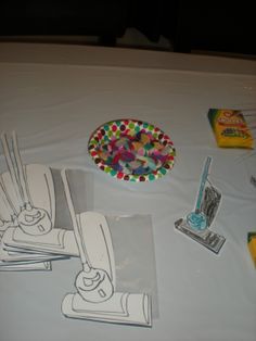 the table is covered with paper and crafting supplies