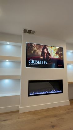 a large television mounted to the side of a wall above a fire place in a living room