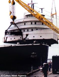 a large boat being lifted by a crane