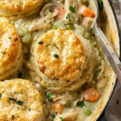 chicken pot pie with biscuits and peas in a skillet, ready to be eaten