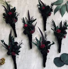 there are many flowers on the wall and one is made out of black paper with red roses