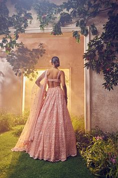 Featuring a peach tulle lehenga embroidered fully by hand with various ornamental lustre sequences and Japanese bugle beads. It is paired with a scallop dupatta with crystal drops and blouse.From Aneesh Agarwaal's Ellora collection.DELIVERY TIMEPlease allow 8-12 weeks for your outfit to arrive.FABRIC DETAILSNetProfessional cleaning only. Peach Anarkali Set For Reception With Traditional Drape, Peach Lehenga With Traditional Drape For Reception, Traditional Drape Peach Lehenga For Reception, Floor-length Peach Choli For Reception, Peach Floor-length Lehenga For Reception, Floor-length Peach Lehenga For Reception, Peach Sets With Mirror Work For Reception, Peach Reception Set With Mirror Work, Peach Reception Sets With Mirror Work