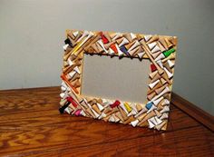 a small wooden frame made out of colored crayons on top of a table