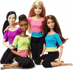 four dolls are posed together in front of a white background and one is wearing black pants