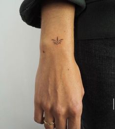 a woman's arm with a small tattoo on the left side of her wrist