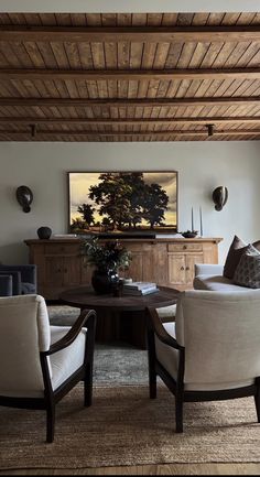 a living room filled with furniture and a wooden ceiling