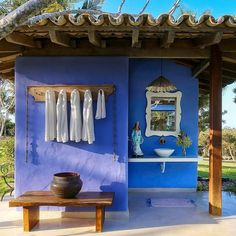 a blue and white house with clothes hanging on the wall