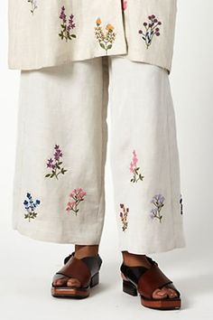 Beige linen pant with multicolour floral embroidered motifs. - Aza Fashions Beige Floral Embroidery Pants For Summer, Beige Floral Embroidered Bottoms For Spring, Spring Beige Floral Embroidered Bottoms, Spring Wide-leg Pants With Floral Embroidery, Summer Linen Bottoms With Floral Embroidery, Beige Cotton Pants With Floral Embroidery, Spring Wide Leg Bottoms With Chikankari Embroidery, Bohemian Bottoms With Multicolor Floral Embroidery, Summer Embroidered Beige Pants