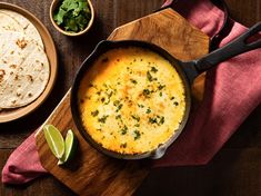 a skillet filled with cheese next to tortillas