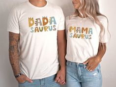 Introducing our super cute dinosaur theme birthday t-shirts. These shirts are high quality and made with 100% soft ringspun cotton for very comfortable wear.   NB: We have multiple options for Mom and Dad in the listings drop-down menu, please double-check you chose the correct one. The Rabbit Skins NATURAL infant tee sizes 6, 12, 18, and 24 months are slightly darker than the Bella Canvas toddler, youth, and adult shirts. We currently do not have the bodysuit in the natural color. Bella Canvas White T-shirt With Dinosaur Print For Birthday, Unisex White Top With Dinosaur Print, White Family Matching T-shirt With Dinosaur Print, Family Matching White T-shirt With Dinosaur Print, Unisex Dinosaur Print Tops For Birthday, Family Matching White Dinosaur Print T-shirt, White Dinosaur Print T-shirt For Family Matching, Gender-neutral Dinosaur Print Top For Birthday, Unisex White T-shirt With Dinosaur Print